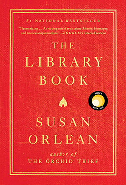 Cover - The Library Book by Susan Orlean. Bright Rea with double line gold frame around title and author name